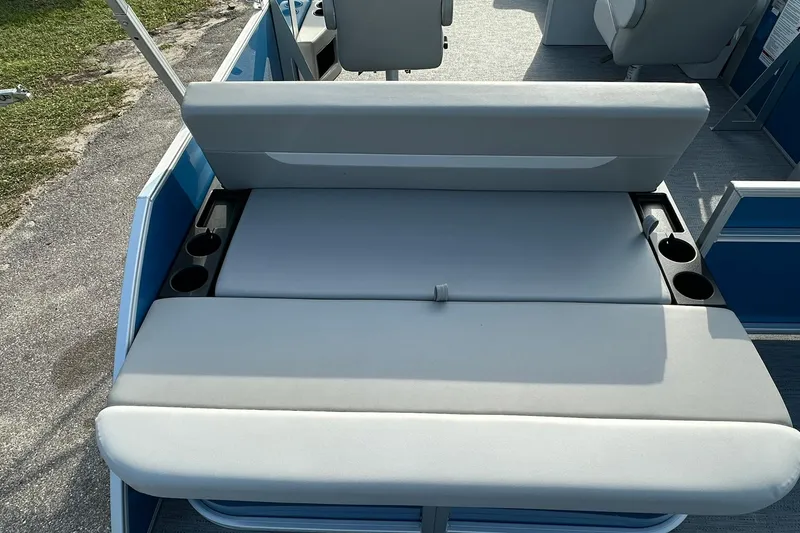 Slide: The Image of 2026 Sweetwater EX 2286 SFLX boat seating with cup holders and gray upholstery. - 24