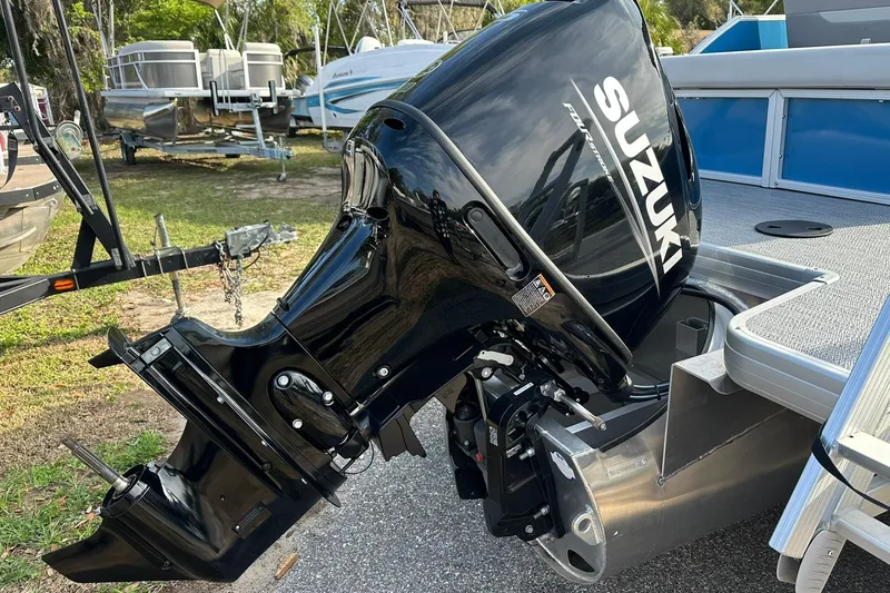 Slide: The Image of 2026 Sweetwater EX 2286 SFLX boat with Suzuki outboard motor in a marina setting. - 30