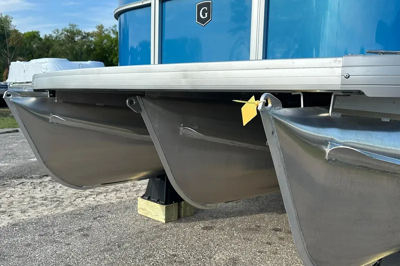 Slide: The Image of 2026 Sweetwater EX 2286 SFLX pontoon boat, close-up of aluminum pontoons and blue exterior. - 4