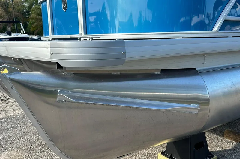 Slide: The Image of 2026 Sweetwater EX 2286 SFLX pontoon boat, blue exterior, aluminum hull detail. - 5