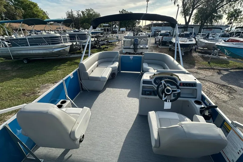 Slide: The Image of 2026 Sweetwater EX 2286 SFLX pontoon boat with spacious seating and modern helm. - 8