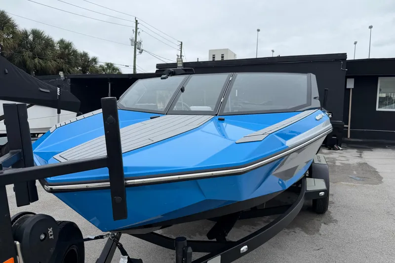 Slide: The Image of 2026 Nautique Ski Nautique boat in vibrant blue on a trailer. - 8