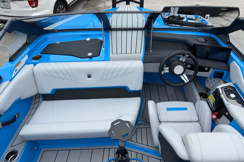 Slide: The Image of 2026 Nautique Ski Nautique interior with blue and white seating, modern dashboard, and steering wheel. - 9
