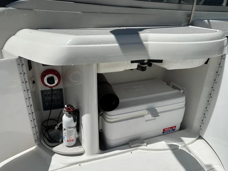 Slide: The Image of Storage compartment on a 2000 Formula 330 SS boat with cooler and fire extinguisher. - 11