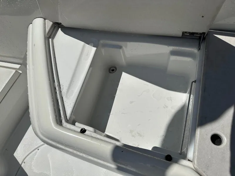 Slide: The Image of Storage compartment of a 2000 Formula 330 SS boat, featuring a clean, white interior. - 13