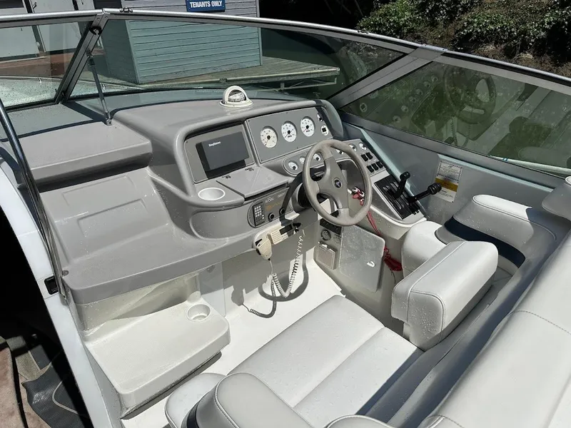 Slide: The Image of 2000 Formula 330 SS boat cockpit with steering wheel and control panel. - 14