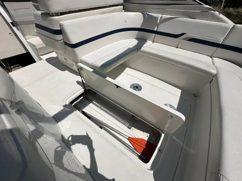 Slide: The Image of 2000 Formula 330 SS boat interior with open storage compartment and white seating. - 21