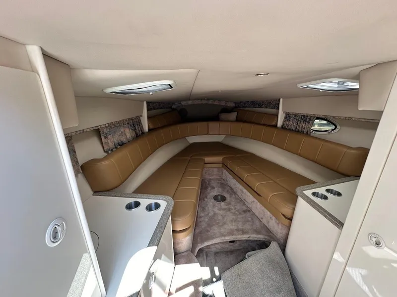 Slide: The Image of Interior of 2000 Formula 330 SS boat with beige seating and skylights. - 24