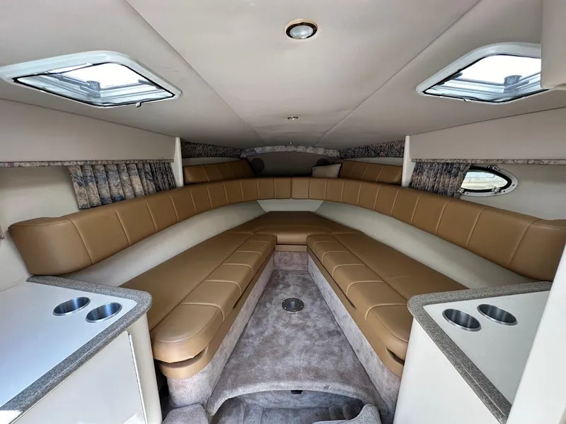 Slide: The Image of Interior of 2000 Formula 330 SS boat with beige seating and cup holders. - 25