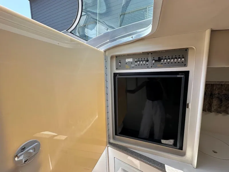Slide: The Image of Interior view of a 2000 Formula 330 SS boat with control panel and window. - 27