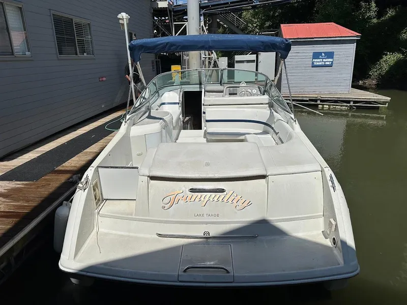 Slide: The Image of 2000 Formula 330 SS boat docked, featuring "Tranquility" name on the stern. - 35