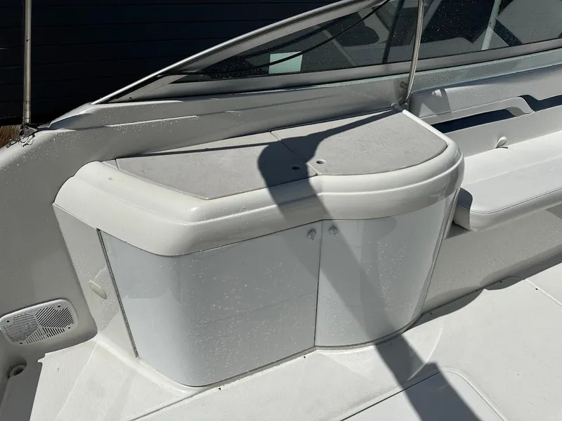Slide: The Image of 2000 Formula 330 SS boat interior with white seating and storage compartment. - 9