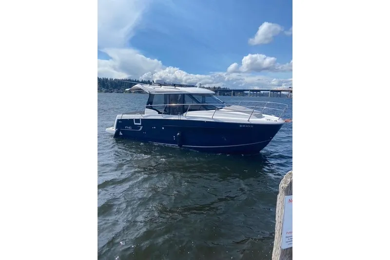 The Image of 2020 Jeanneau NC 895 boat on a sunny day, floating on calm waters. - 0