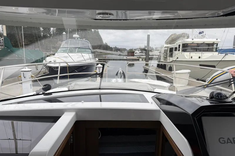 Slide: The Image of View from Jeanneau NC 895, 2020 model, docked at a marina with other boats. - 10