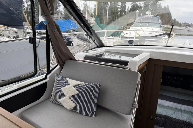 Slide: The Image of Interior of 2020 Jeanneau NC 895 boat with cozy seating and nautical decor. - 17