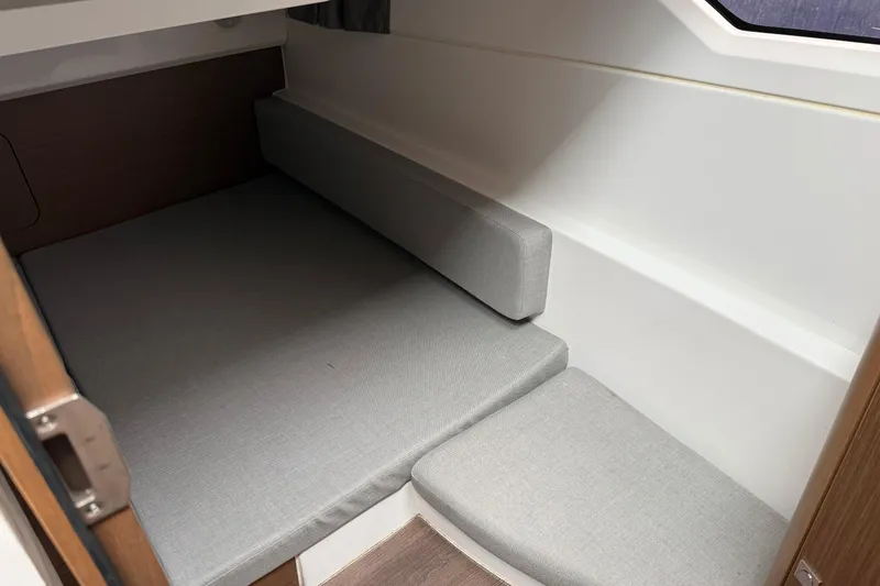Slide: The Image of Cozy cabin interior of 2020 Jeanneau NC 895 with gray cushions and wooden accents. - 21
