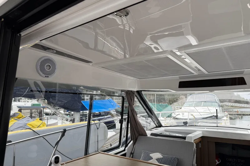 Slide: The Image of Interior view of 2020 Jeanneau NC 895 boat with modern design and marina backdrop. - 25