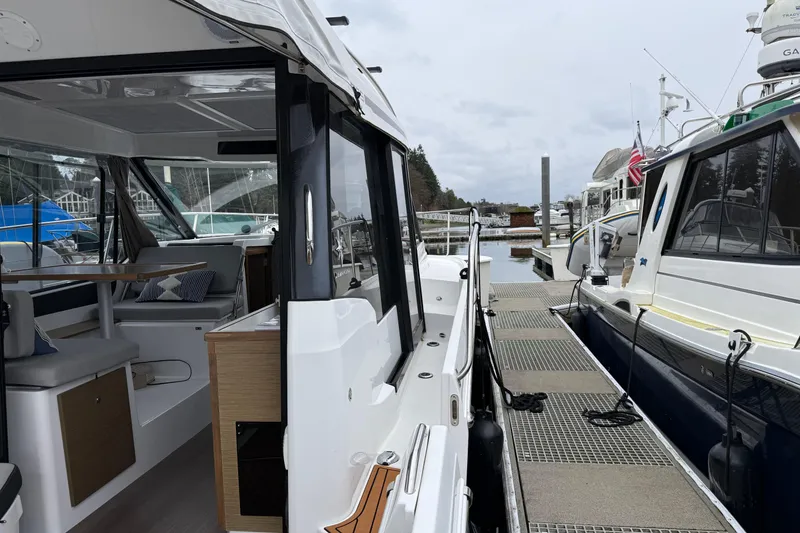 Slide: The Image of 2020 Jeanneau NC 895 docked, showcasing interior seating and exterior design. - 26