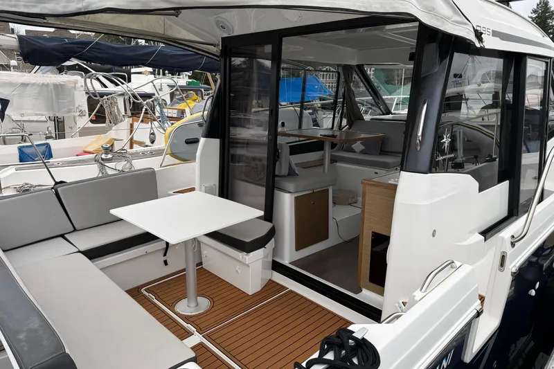Slide: The Image of 2020 Jeanneau NC 895 boat with open cockpit, seating, and interior view. - 4