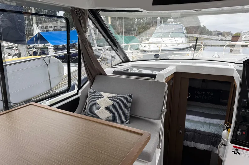Slide: The Image of Interior of 2020 Jeanneau NC 895 boat with seating and cabin view. - 8