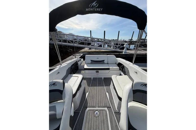 Slide: The Image of 2015 Monterey 268SS Super Sport boat interior with seating and canopy at dock. - 4