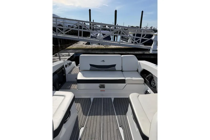 Slide: The Image of 2015 Monterey 268SS Super Sport boat interior with white seating and dock view. - 5