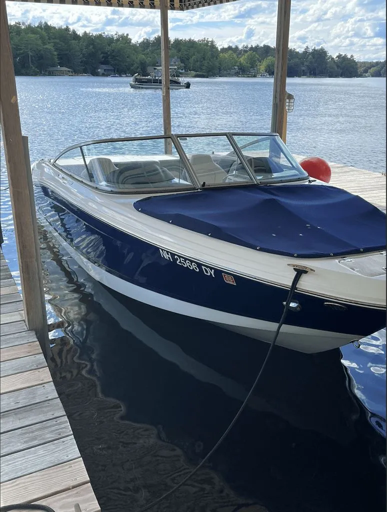 Slide: The Image of 2020 Chaparral 21 SSI Sport boat docked on a lake. - 3