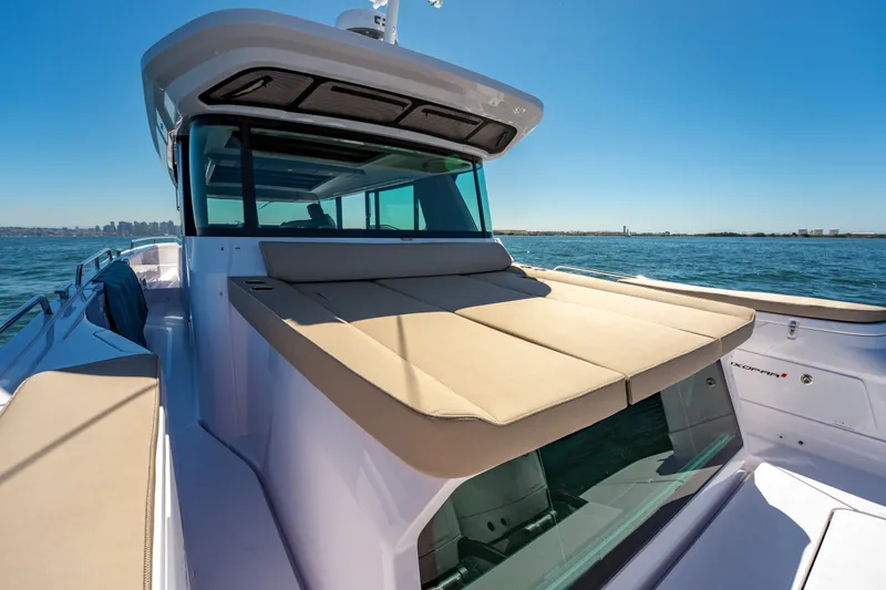 Slide: The Image of 2026 Axopar 45 XC Cross Cabin boat with sun deck on open water. - 18