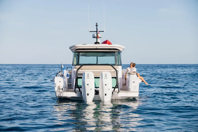 Slide: The Image of 2026 Axopar 45 XC Cross Cabin on open sea, featuring triple outboard engines. - 5