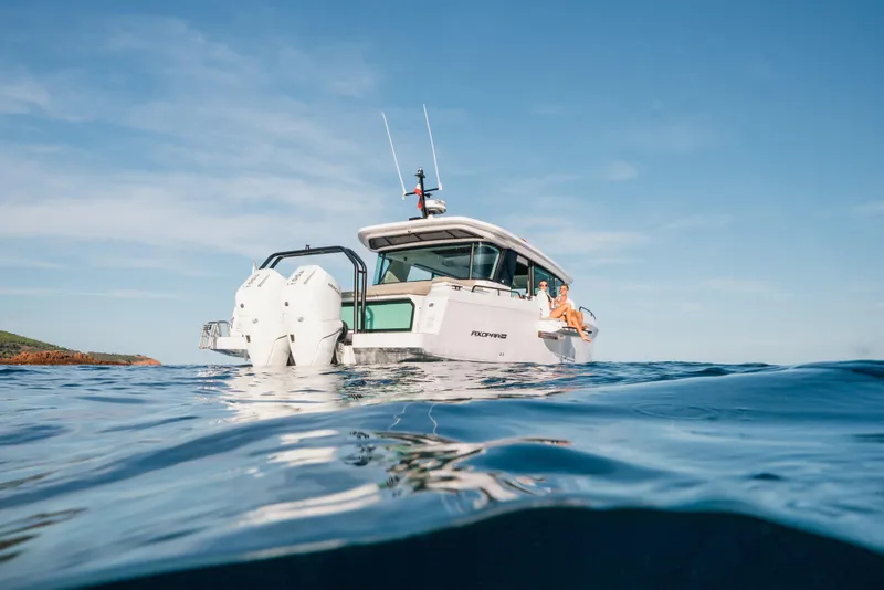 Slide: The Image of 2026 Axopar 45 XC Cross Cabin on open water, showcasing sleek design and powerful engines. - 6