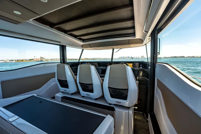 Slide: The Image of Interior view of 2026 Axopar 45 XC Cross Cabin, showcasing modern seating and panoramic windows. - 25