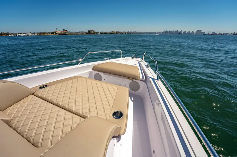 Slide: The Image of 2026 Axopar 45 XC Cross Cabin boat with luxurious sunbathing area on open water. - 21