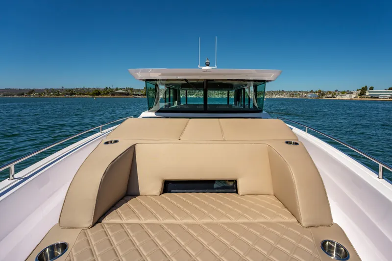 Slide: The Image of 2026 Axopar 45 XC Cross Cabin boat with luxurious deck seating on open water. - 17