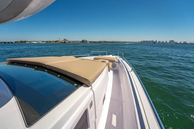 Slide: The Image of 2026 Axopar 45 XC Cross Cabin cruising on open water under clear blue sky. - 20