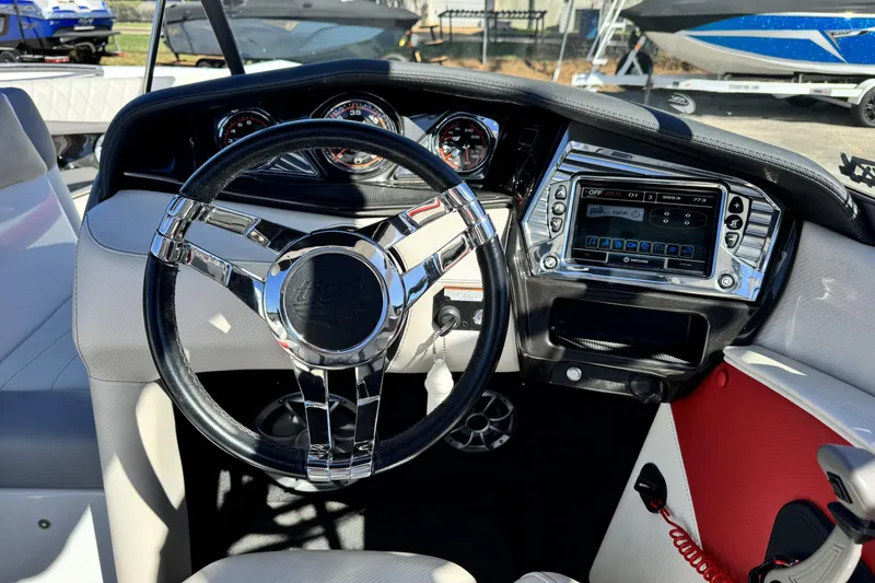 Slide: The Image of 2015 Tigé Z3 boat dashboard with steering wheel and control panel. - 10