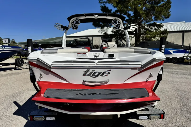Slide: The Image of 2015 Tigé Z3 boat with red and white design, parked outdoors. - 4