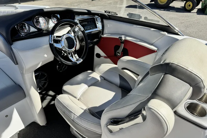 Slide: The Image of Interior of a 2015 Tigé Z3 boat featuring a sleek steering wheel and modern dashboard. - 9