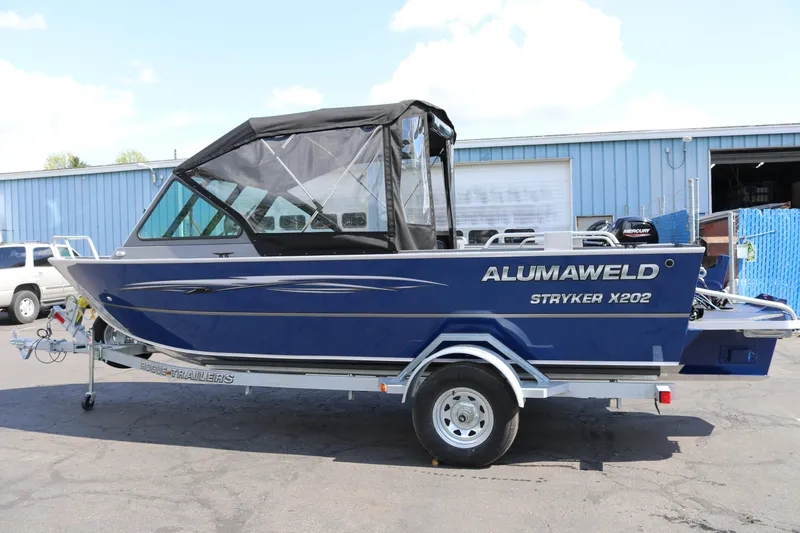 The Image of 2025 Alumaweld Stryker X202 boat on trailer, blue exterior, parked outdoors. - 0