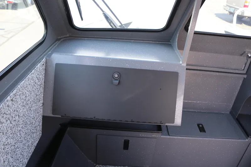 Slide: The Image of Interior view of 2025 Alumaweld Stryker X202 boat, featuring storage compartment and window. - 11