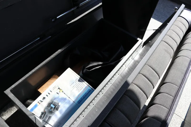 Slide: The Image of Storage compartment in 2025 Alumaweld Stryker X202 boat, featuring manuals and accessories. - 18