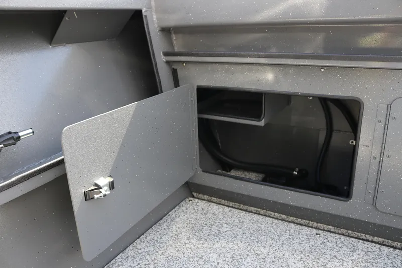 Slide: The Image of Open storage compartment in 2025 Alumaweld Stryker X202 boat interior. - 22