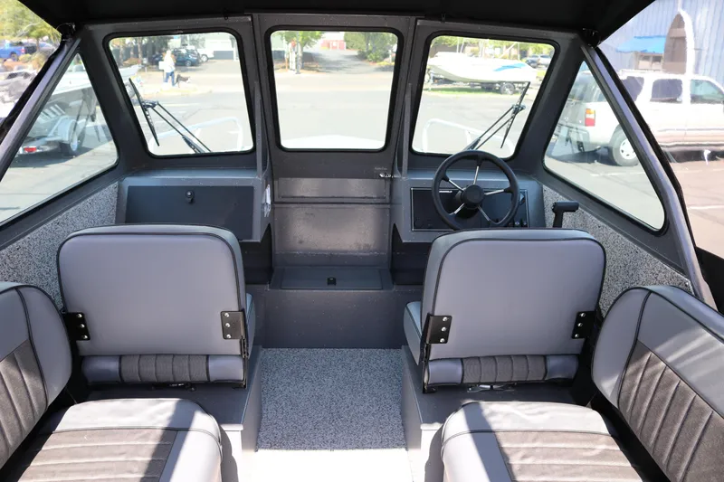 Slide: The Image of Interior of 2025 Alumaweld Stryker X202 boat with seating and steering wheel. - 9