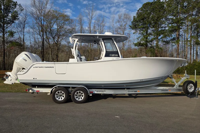 The Image of 2026 Sportsman Open 282 Center Console boat on trailer, parked outdoors. - 0