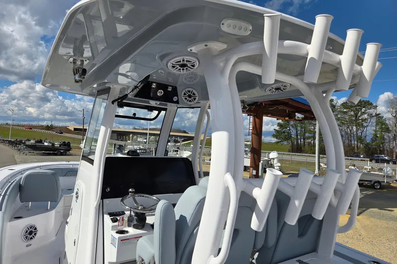 Slide: The Image of 2026 Sportsman Open 282 Center Console boat with rod holders and modern helm. - 12