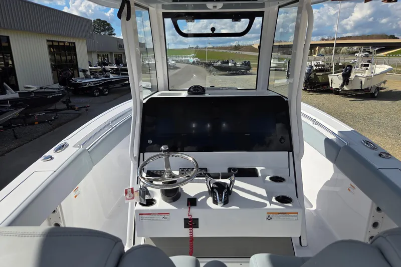 Slide: The Image of 2026 Sportsman Open 282 Center Console boat interior with steering wheel and dashboard. - 13