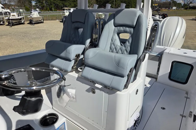 Slide: The Image of 2026 Sportsman Open 282 Center Console with dual cushioned seats and steering wheel. - 14