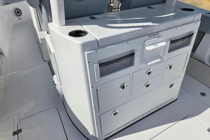 Slide: The Image of 2026 Sportsman Open 282 Center Console boat interior with storage compartments and cup holders. - 15