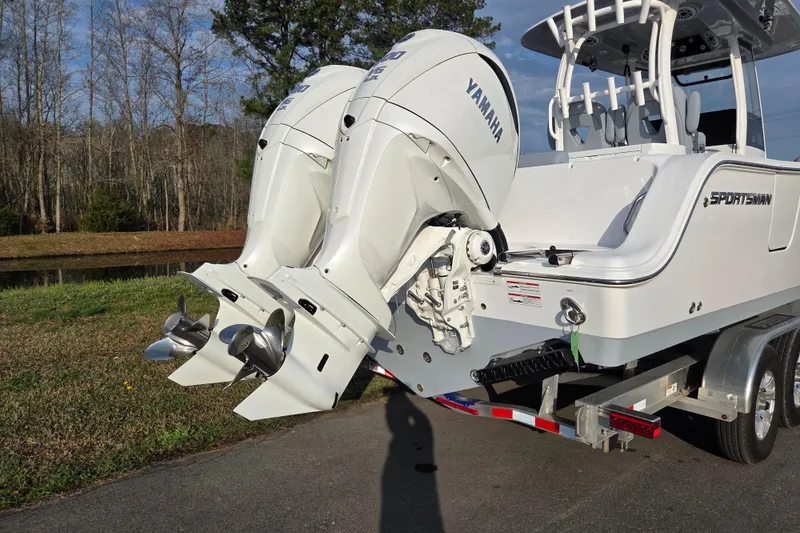 Slide: The Image of 2026 Sportsman Open 282 Center Console boat with dual Yamaha outboard engines on a trailer. - 3