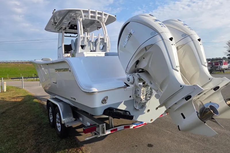Slide: The Image of 2026 Sportsman Open 282 Center Console boat on trailer with dual outboard engines. - 4