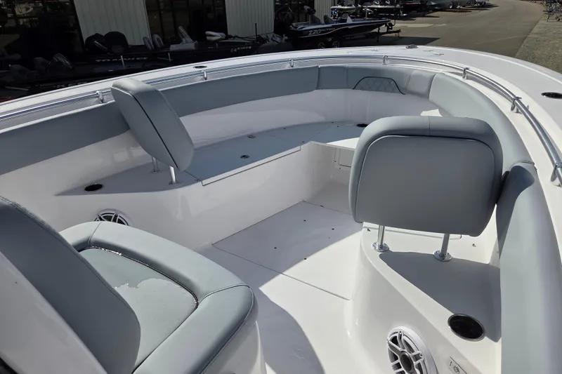 Slide: The Image of 2026 Sportsman Open 282 Center Console boat interior with cushioned seating and storage. - 7